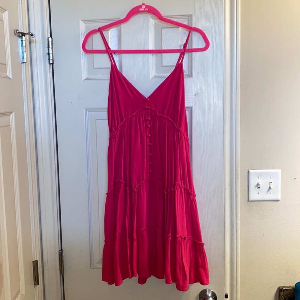 New In. Float pink dress with decorative buttons and zipper. Adjustable straps.